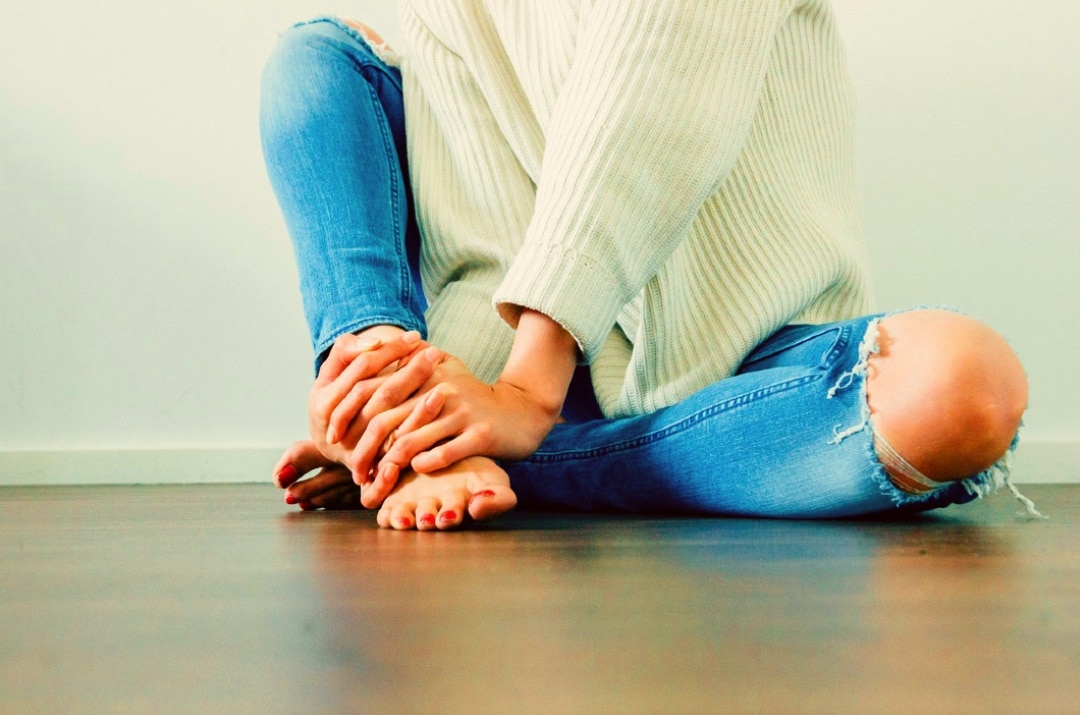 girl knee jeans blue osteoarthritis sweater white sitting model pose