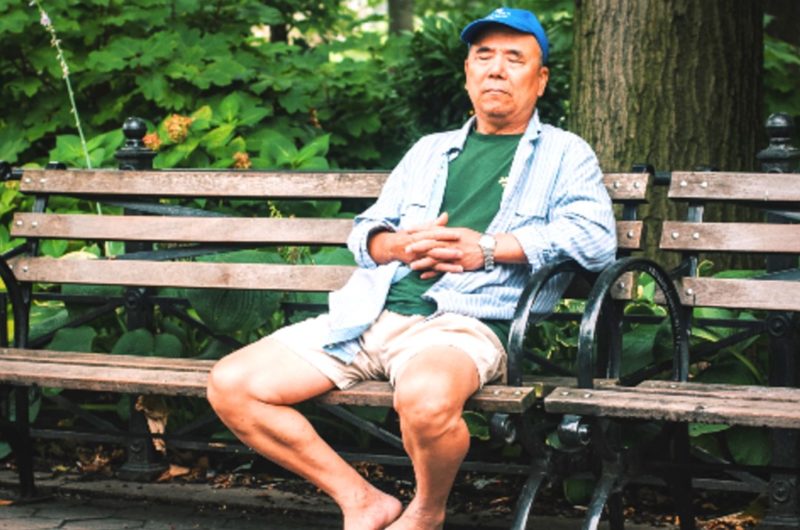 middle-aged man sitting on a park bench