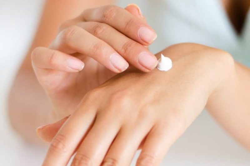 woman applying cream to her hand